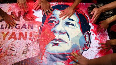 Duterte supporters touch a portrait of him during a rally in Manila. J Gerard Seguia / Pacific Press / LightRocket via Getty Images