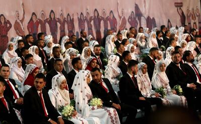 Newly-wed couples are seen during a mass wedding ceremony for 150 Palestinian couples and 50 Lebanese couples. AFP