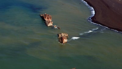 The black beach on Iwo To, formerly known as Iwo Jima, was stormed by thousands of U.S. Marines Feb. 19, 1945 during the Battle of Iwo Jima. Many relics of the war remain in the waters and scattered among the sands.