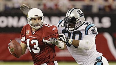 Julius Peppers, pictured pouncing on Arizona's Kurt Warner, has joined the Chicago Bears.