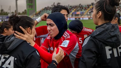 Azizi Khursand of Afghanistan, centre, in the huddle before the Fifa Unites match between Afghan Women United and Tunisia. AFP