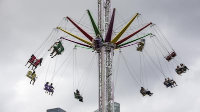Visitors ride a swing in the central business district of Singapore. Bloomberg