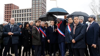 France's President Emmanuel Macron, surrounded by officials, attends the inauguration ceremony of the Paris 2024 Olympic village in Saint-Denis, north of Paris. AP