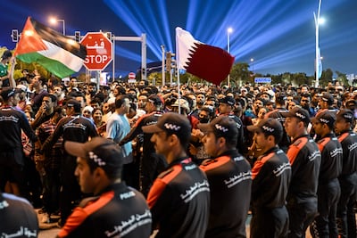 Police officers stand guard to prevent members of the public entering the overcrowded Fifa Fan Festival at Al Bidda park in Doha. AFP