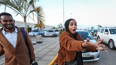 Kenyan student Hubbi Abdirahman greets relatives in Nairobi after she was evacuated from Sudan. EPA