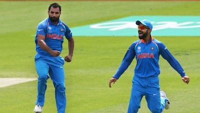 India's Mohammed Shami, left, celebrates the wicket of New Zealand's Neil Broom with India's captain Virat Kohli during the ICC Champions Trophy Warm-up match between India and New Zealand at The Oval in London on May 28, 2017. AFP