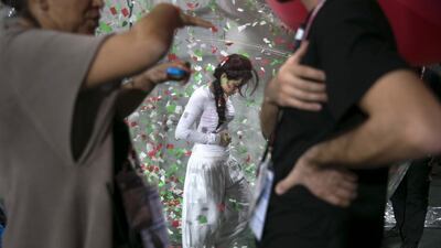 Manuela Velazquez is surrounded by confetti while she stands in a plastic ball preparing for the final dress rehearsal of the Fifa U7 World Cup closing ceremony. Silvia Razgova / The National