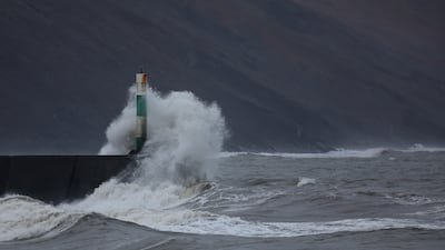 Waves hit the harbour wall during strong winds in Aberystwyth, in Wales. Reuters