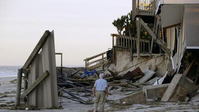 HV Bailey looks at damage to a neighbour’s home at Ponte Vedra Beach, Florida. Charlie Riedel / AP Photo