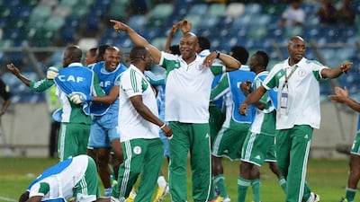 Nigeria’s coach Stephen Keshi (C) and members of his staff celebrate the fourth goal of their team during the 2013 African Cup of Nations semi-final football match Mali vs Nigeria on February 6, 2013 in Durban. AFP PHOTO / FRANCISCO LEONG