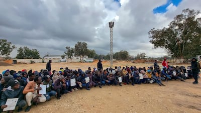 Migrants await the distribution of basic necessities at Ain Zara detention centre in Tripoli on January 12, 2022. AFP