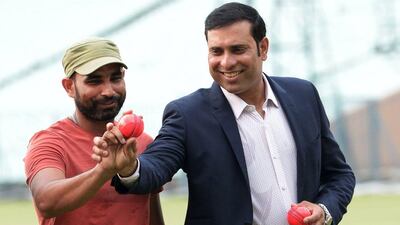 Former Indian batsman VVS Laxman, right, and Indian pace bowler Mohammed Shami participate in an event to promote pink cricket balls at Eden Gardens in Kolkata on June 16, 2016. Eden Gardens will host India's first day-night game with a pink ball starting from June 19, with Bhovanipur Club taking on Mohun Bagan AC in a four-day game of the CAB League. AFP / Dibyangshu SARKAR