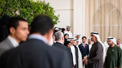 Sheikh Mohamed meets the Year 12 graduates with, right, Sheikh Hamdan bin Zayed, Ruler’s Representative of Al Dhafra Region. Abdulla Al Bedwawi / UAE Presidential Court