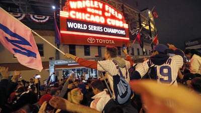 Chicago Cubs fans celebrate in front of Wrigley Field in Chicago. Charles Rex Arbogast / AP