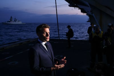 French President Emmanuel Macron addresses medias as he visits the French aircraft carrier Charles de Gaulle. AFP