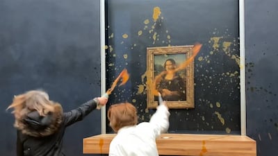 Environmental activists hurl soup at Leonardo Da Vinci's Mona Lisa, at the Louvre museum in Paris, on January 28. A bullet-proof glass protects the painting. AFP