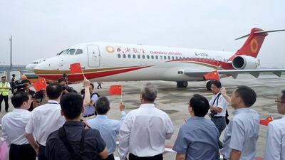 People celebrate the landing of flight EU6679, the first commercial service of ARJ21-700, at Hongqiao airport in Shanghai, China, on June 28, 2016. EPA