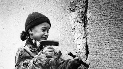 A little girl chisels away at the Berlin Wall from the east side on New Year's Eve, 31st December 1989. August 13th 2011 will mark 50 Years Since East German Troops Sealed The Border Between East And West Berlin. (File Photo by Steve Eason/Hulton Archive/???