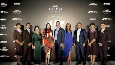Etihad cabin crew pose with, from left, Amina Taher, vice president corporate affairs, Etihad Aviation Group; actress Liv Tyler; Tony Douglas, group chief executive officer, Etihad Aviation Group; IMG supermodel Joan Smalls; and Robin Kamark, chief commercial officer, Etihad Aviation Group
