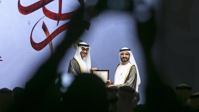 A member of the audience takes a photo as Sheikh Mohammed bin Rashid, Vice President and Ruler of Dubai, is handed his award by Sheikh Mohammed bin Zayed, Crown Prince of Abu Dhabi and Deputy Supreme Commander of the Armed Forces. Silvia Razgova / The National