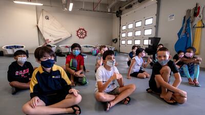 Amity children take part in a safety briefing before heading out for a morning of sailing.