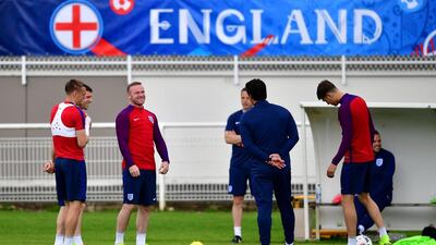 Wayne Rooney of England shares a joke with Gary Neville, Coach of England during a training session ahead of the UEFA Euro 2016 match against Slovakia at Stade du Bourgognes on June 19, 2016 in Chantilly, France. (Photo by Dan Mullan/Getty Images)