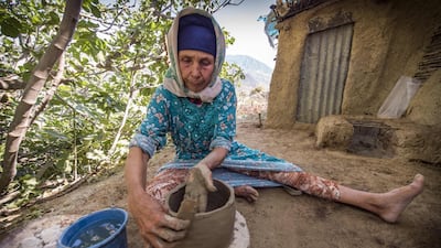 Moroccan potter Fatima Harama from the M'tioua tribe works on pottery near the village of Ourtzagh, Morocco. AFP