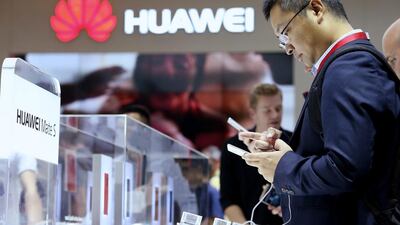 Visitors to the IFA consumer electronics trade fair in Berlin try out the Huawei Mate S smartphone at the company’s stand. Sean Gallup / Getty Images