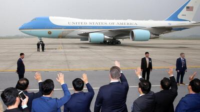 Officials wave at Air Force One as US President Donald J. Trump leaves from Nom Bar International Airport in Hanoi. EPA