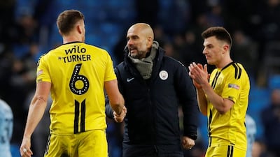 Manchester City manager Pep Guardiola shakes hands with Burton Albion's Ben Turner after the match. Reuters
