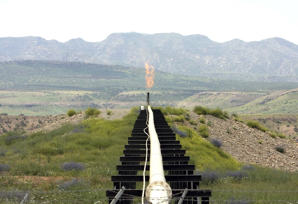 A flame rises from a pipeline at Iraq's Tawke oilfield. Reuters