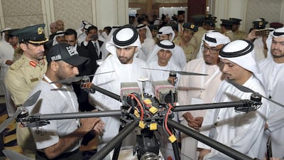 Sheikh Mansoor bin Mohammed tours the Unmanned Aerial System Forum in Dubai. Seen with Lt Gen Dhahi Khalfan, head of general secrity for Dubai, and Maj Gen Abdullah Al Marri, commander-in-chief of Dubai Police. Dubai Police