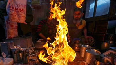 A cook prepares harissa, a traditional Kashmiri meat and rice dish, on a cold winter's morning in Srinagar, the summer capital of Indian Kashmir. EPA