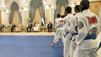 Sheikh Mohamed bin Zayed, Crown Prince of Abu Dhabi and Deputy Supreme Commander of the UAE Armed Forces and Jair Bolsonaro, President of Brazil, watch a Jiu Jitsu display during an official reception at Qasr Al Watan. Ministry of Presidential Affairs
