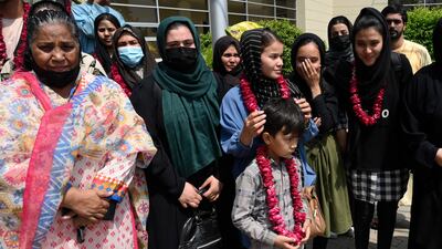 Members of the football team and their families pose for a photograph after meeting Pakistan Football Federation officials in Lahore. AP