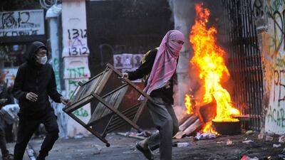 Protesters carry items to be burnt outside the regional parliament building during a protest against government spending priorities, in Bandung, Indonesia's West Java province. Reuters