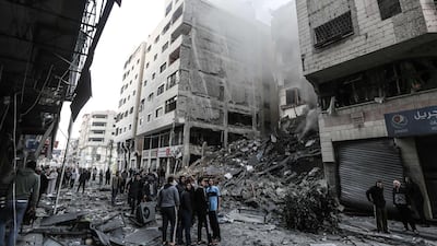 Palestinians check the damage in a neighbourhood in Gaza City. AFP Photo