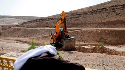 A bedouin man watches as an excavator digs in the Palestinian Bedouin village of Khan Al Ahmar, east of Jerusalem in the occupied West Bank. AFP