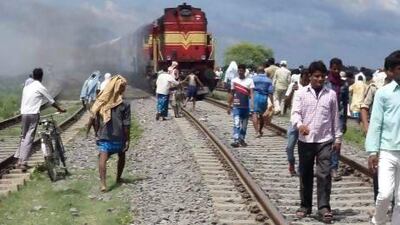 Coaches of the Rajya Rani Express, set on fire by an angry mob, burn after the train ploughed into a crowd of Hindu pilgrims at the Dhamara Ghat railway station in the Khagaria district.