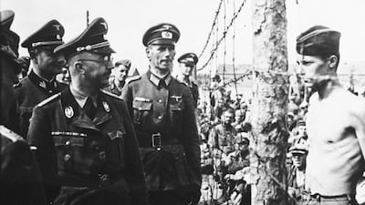 1941: The head of the Gestapo, Heinrich Himmler, looks at a Soviet prisoner of war (right) during his inspection of a concentration camp in Belarus in 1941. Himmler was responsible for co-ordinating the mass murder of Jewish people in the Third Reich. The photo illustrates the contrast of power between the two figures, and it is the defiance in the prisoner's stance that makes it so very memorable. National Archives / Newsmakers