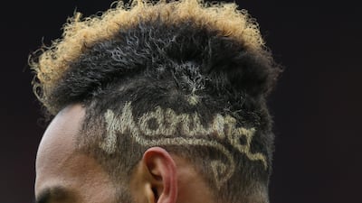 Pierre-Emerick Aubameyang of Arsenal often sports names and patterns shaved intot he side of his head. Getty Images