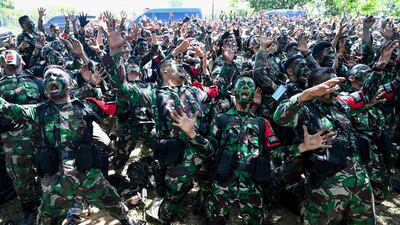 Soldiers from the Iskandar Muda military command sing after exercises in Indonesia. AFP