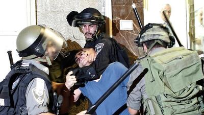 Israeli police arrest a Palestinian man during clashes with the Israeli police in East Jerusalem after the funeral of Palestinian teenager Mohammed Sinokrot, 16, who was wounded by Israeli gunfire on August 31 and died from his injuries on September 8. Thomas Coex / AFP