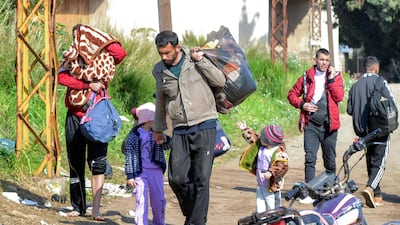 Syrians fleeing violence enter northern Lebanon after crossing the Nahr Al Kabir. AFP