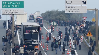 Migrants hope to board lorries at the Calais ferry terminal, France, to try to reach England. Reuters