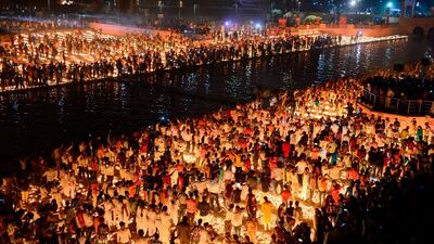 Hindu devotees light earthen lamps on the banks of the River Sarayu on the eve of Diwali festival during an event organised by the Uttar Pradesh government, in Ayodhya. AFP