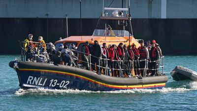 Rescued migrants are brought in to shore. PA