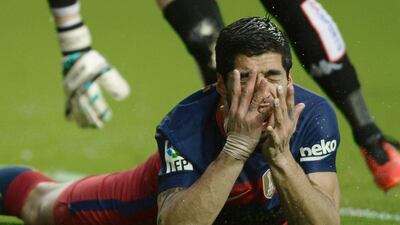 Luis Suarez lies on the ground after a failed shot on goal during Barcelona’s match against Sporting Gijón. Miguel Riopa / AFP Photo