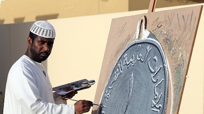 The Emirati artist Abdul Rauf Khalfan in Dubai with one of his artworks. Satish Kumar / The National