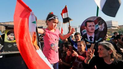Citizens carry portraits of president Bashar Al Assad as they gather to condemn the strikes carried out by the United States, Britain and France against the Syrian regime. Louai Beshara / AFP Photo